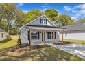 Charming single-story home with a welcoming front porch and black shutters and door at 619 Ray St, Selma, NC 27576