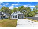 Charming exterior view of this light blue home, featuring a well-manicured lawn and inviting facade at 621 Ray St, Selma, NC 27576