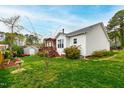 Spacious backyard with lush green grass, mature trees, and a cozy deck perfect for entertaining at 6819 Franklin Heights Rd, Cary, NC 27518