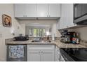 Modern kitchen with granite countertops, white cabinets, stainless steel appliances and opening to living space at 708 Martin Luther King Jr. Blvd # E2, Chapel Hill, NC 27514