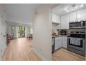 Bright kitchen with white cabinets, stainless steel appliances, and hardwood floors open to living room at 708 Martin Luther King Jr. Blvd # E2, Chapel Hill, NC 27514