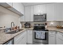 Updated kitchen with stainless steel appliances, white cabinets and granite countertops at 708 Martin Luther King Jr. Blvd # E2, Chapel Hill, NC 27514