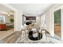 Light-filled dining room adjacent to the kitchen, featuring a stylish table and access to the backyard at 7122 Guess Rd, Hillsborough, NC 27278