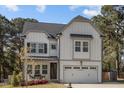 Lovely two-story home with a front porch and a two-car garage at 802 Knollwood Dr, Apex, NC 27502