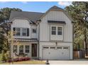 Beautiful new home with white siding, a covered porch, and an attached two-car garage at 802 Knollwood Dr, Apex, NC 27502