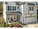 Inviting front porch with comfortable seating and a view of the landscaped yard at 802 Knollwood Dr, Apex, NC 27502