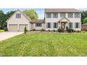 Charming two-story home with a lush green lawn, two-car garage, and inviting curb appeal at 803 Driftwood Dr, Gibsonville, NC 27249