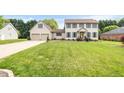 Well-maintained two-story home featuring a lush green lawn and an attached two-car garage at 803 Driftwood Dr, Gibsonville, NC 27249
