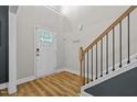 Bright foyer featuring hardwood floors, a white front door with stained glass, and a staircase at 810 Mulberry Rd, Spring Hope, NC 27882