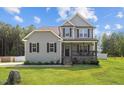 Traditional two-story home with a welcoming covered front porch, perfect for relaxing at 810 Mulberry Rd, Spring Hope, NC 27882