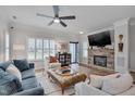 Beautifully decorated living room with stone fireplace, TV, hardwood floors, and comfortable seating arrangement at 900 Ambergate Sta, Apex, NC 27502