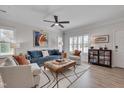 Cozy living room features lots of natural light, ceiling fan, modern furnishings, and hardwood flooring at 900 Ambergate Sta, Apex, NC 27502