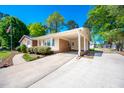 Spacious driveway leading to a covered carport, with a view of the well-maintained home and yard at 926 Allister Rd, Durham, NC 27703