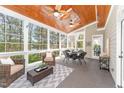 Bright sunroom with vaulted wood ceiling, ceiling fans, and scenic views at 944 Alden Bridge Dr, Cary, NC 27519