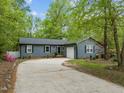 Charming single-story home featuring an attached garage and a concrete driveway at 1015 Castalia Dr, Cary, NC 27513