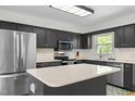 Modern kitchen with stainless steel appliances, quartz counters, and center island at 1015 Castalia Dr, Cary, NC 27513