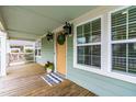 Charming front porch featuring a wooden deck, decorative lights, and views of the surrounding neighborhood at 1023 Kent St, Durham, NC 27707