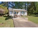 Exterior view of a single-story home with a carport and a well-kept lawn at 105 E Murray Ave, Durham, NC 27704