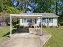 Well-maintained single-story home with a convenient carport and inviting front yard at 105 E Murray Ave, Durham, NC 27704