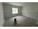 A bright bedroom offers a window bringing light to the interior at 107 Tee Dr, Selma, NC 27576