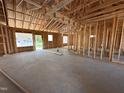 Interior framing shows the layout of the home with studs and a concrete floor at 107 Tee Dr, Selma, NC 27576