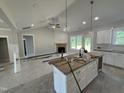 Open-concept kitchen and living area with modern appliances and a spacious island at 107 Tee Dr, Selma, NC 27576