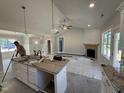 Open-concept kitchen and living area with modern appliances and a spacious island at 107 Tee Dr, Selma, NC 27576
