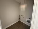 Functional laundry room with tile flooring and utility connections at 107 Tee Dr, Selma, NC 27576