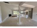 Open-concept living space with fireplace, and kitchen island, providing a modern design at 107 Tee Dr, Selma, NC 27576