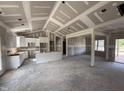 Bright open-concept living and dining area boasting modern design, white cabinets, and ample space at 107 Tee Dr, Selma, NC 27576