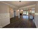 Bright living room featuring modern lighting fixtures, fireplace, and seamless open-concept design to the kitchen at 107 Tee Dr, Selma, NC 27576