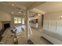 Bright living room featuring a fireplace, ceiling fan, and large windows at 107 Tee Dr, Selma, NC 27576
