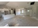 Open concept living room with white wall paneling, and kitchen with white cabinets at 107 Tee Dr, Selma, NC 27576