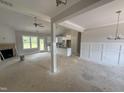 Spacious living room with fireplace, ceiling fan, and bright windows at 107 Tee Dr, Selma, NC 27576