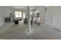 Spacious living room with white trimwork and large windows at 107 Tee Dr, Selma, NC 27576