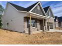 Craftsman-style home with brick accents, vinyl siding, covered porch, and attached two-car garage at 1075 Fairhaven Dr # 51, Mebane, NC 27302