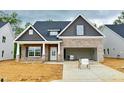 Newly built home with brick and shake shingle exterior, covered entry, and an attached garage at 1075 Fairhaven Dr # 51, Mebane, NC 27302