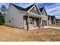Craftsman-style home with brick accents, vinyl siding, covered porch, and attached two-car garage at 1075 Fairhaven Dr # 51, Mebane, NC 27302