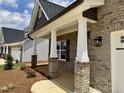 Inviting front porch with brick-based columns and a view of the adjacent home and newly landscaped yard at 1075 Fairhaven Dr # 51, Mebane, NC 27302
