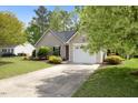 Single-story home featuring a well-maintained lawn, neat landscaping, and an attached one-car garage at 108 Braxberry Way, Holly Springs, NC 27540