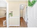 Welcoming foyer with wood floors, neutral walls, and a view into the hallway at 12 Poppy Trl, Durham, NC 27713