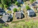 Overhead view of a property featuring a well-manicured lawn, mature trees, and a neatly arranged neighborhood layout at 12808 Edsel Dr, Raleigh, NC 27613