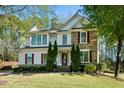 Beautiful two-story home with stone and siding, manicured lawn, and red shutters adding a pop of color at 12808 Edsel Dr, Raleigh, NC 27613