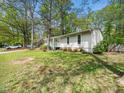Attractive home with manicured lawn, mature trees, and beautiful flower beds at 1312 Rothes Rd, Cary, NC 27511