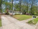 Well-maintained home featuring a spacious driveway and lush greenery at 1312 Rothes Rd, Cary, NC 27511