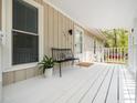 Inviting front porch with a bench and white railing, perfect for relaxing outdoors at 1312 Rothes Rd, Cary, NC 27511