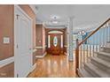 Elegant foyer with hardwood floors, decorative molding, and a wooden front door at 133 Aleah Ct, Clayton, NC 27520