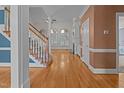 Open living room with hardwood floors, staircase, fireplace, and lots of natural light at 133 Aleah Ct, Clayton, NC 27520