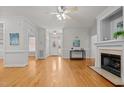 Spacious living room featuring hardwood floors, a fireplace, and ample natural light at 140 Adams Pointe Ct Ct, Angier, NC 27501