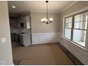 Elegant dining area with wainscoting, modern chandelier, and bright windows at 152 Royal Ave, Selma, NC 27576